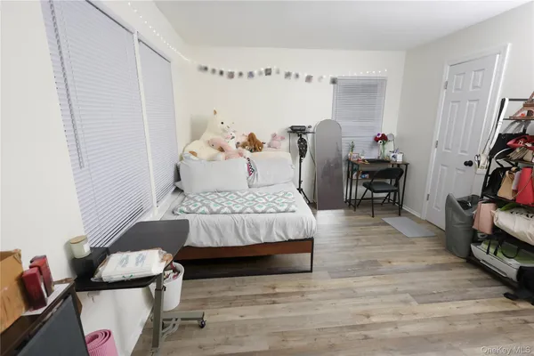 a bedroom with furniture and a wooden floor