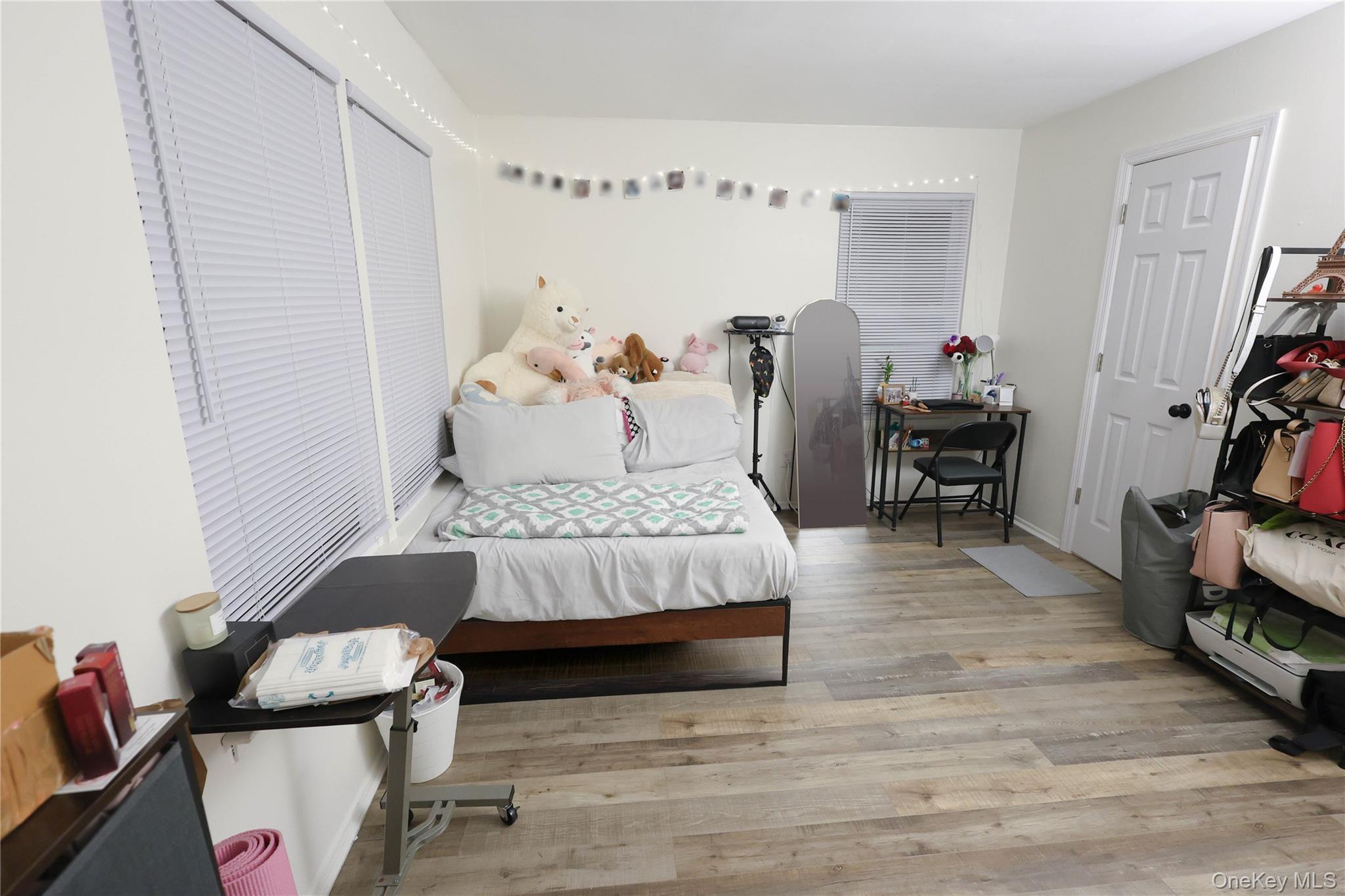 3 Saratoga Court, Unit B Ridge, NY 11961 - Photo 13 of 15 a bedroom with furniture and a wooden floor