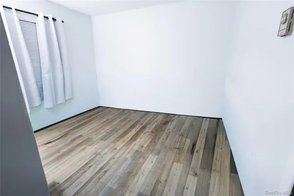 a view of a room with wooden floor