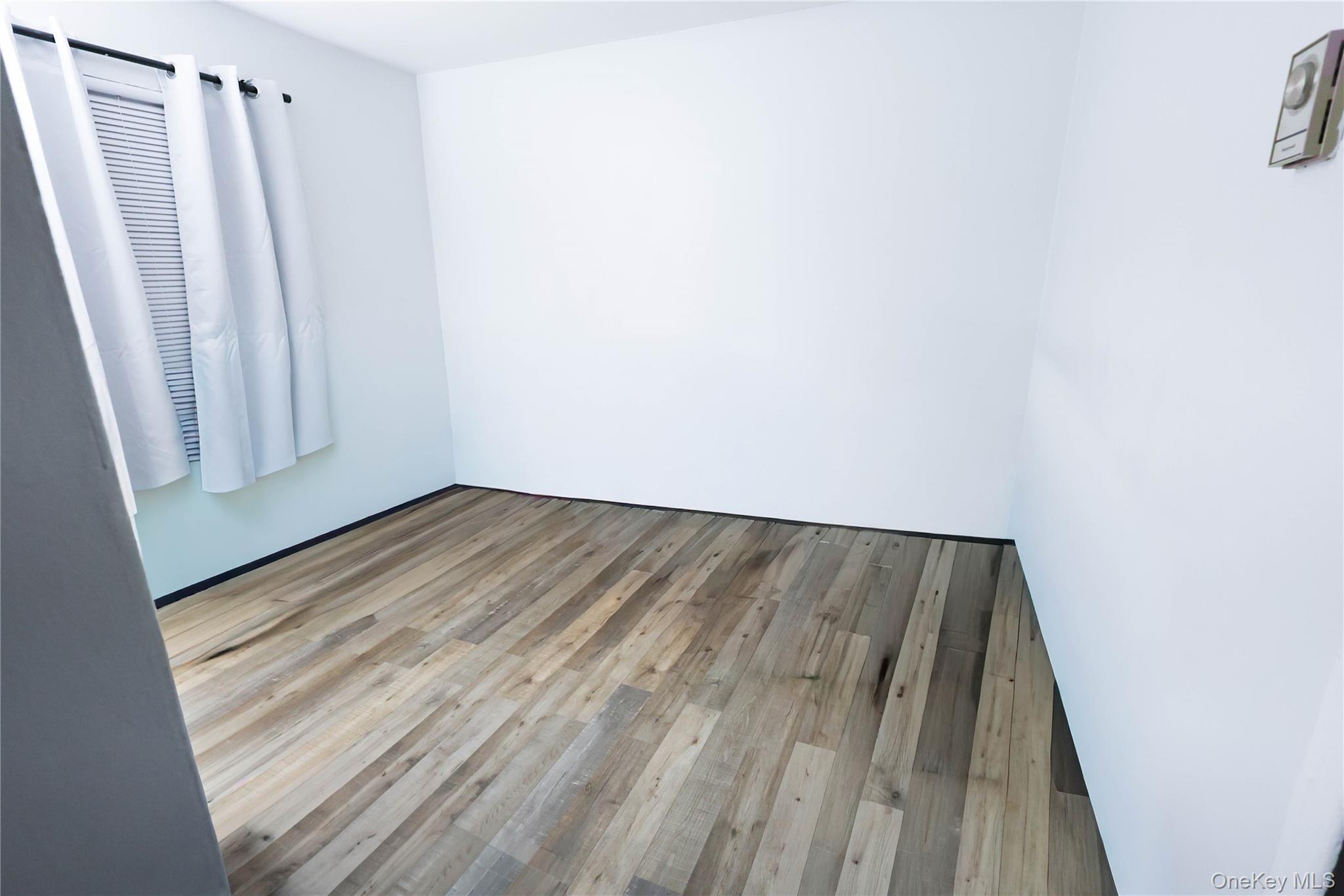 3 Saratoga Court, Unit B Ridge, NY 11961 - Photo 15 of 15 a view of a room with wooden floor