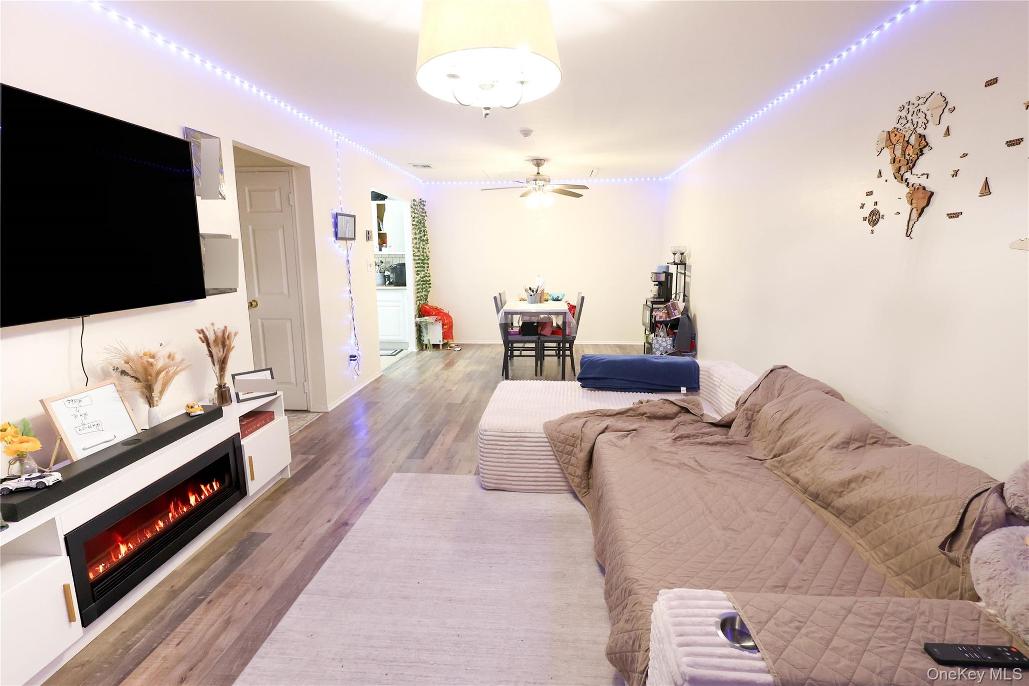 3 Saratoga Court, Unit B Ridge, NY 11961 - Photo 2 of 15 a living room with furniture and a flat screen tv