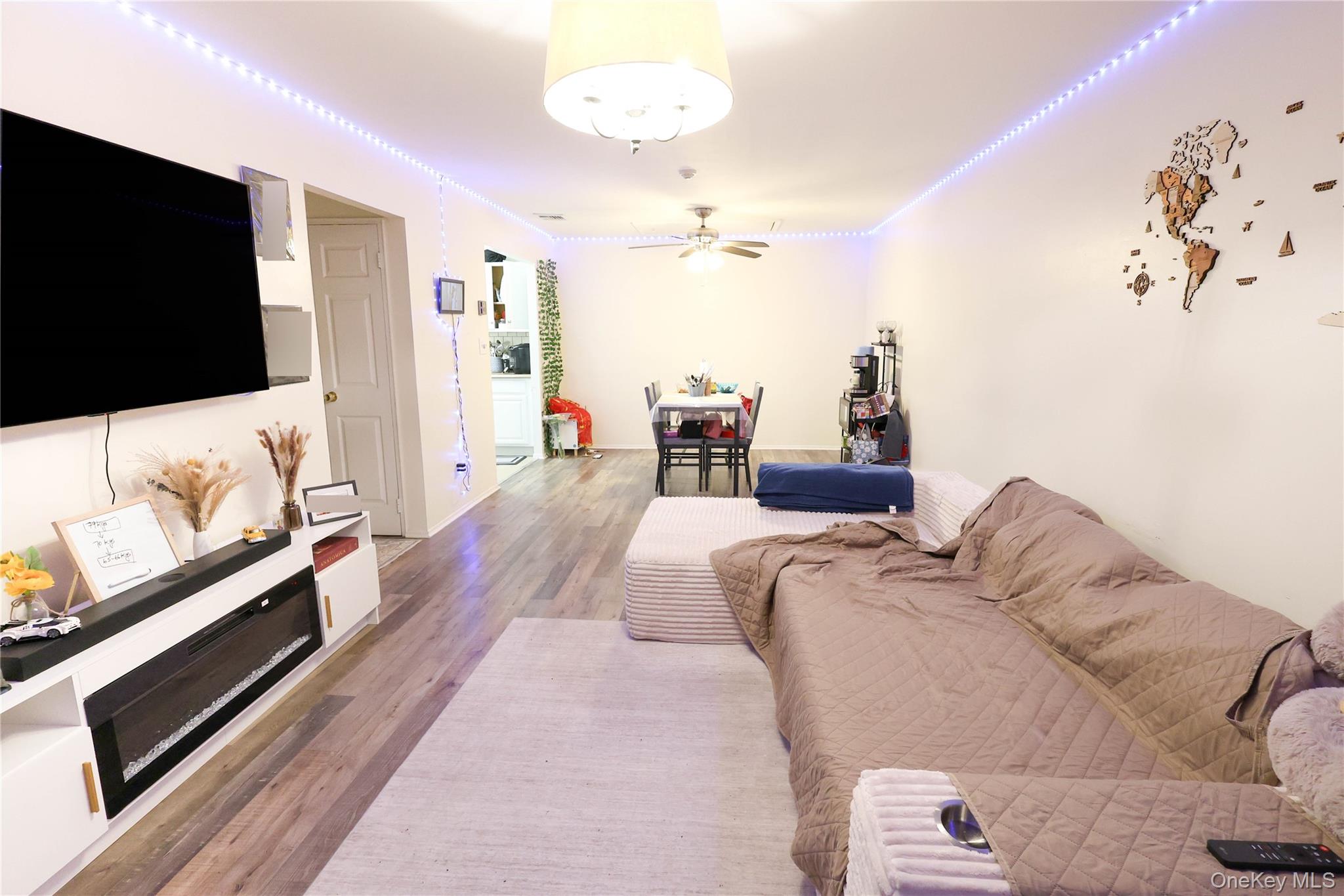 3 Saratoga Court, Unit B Ridge, NY 11961 - Photo 3 of 15 a living room with furniture and a flat screen tv