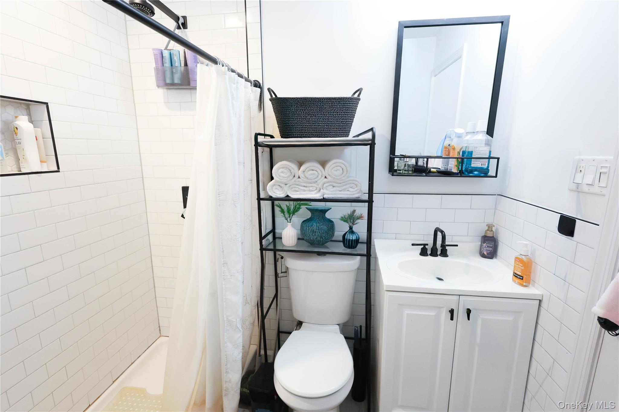 3 Saratoga Court, Unit B Ridge, NY 11961 - Photo 7 of 15 a bathroom with a sink toilet and mirror