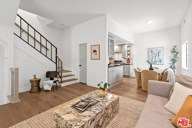 a living room with furniture or couch and a wooden floor