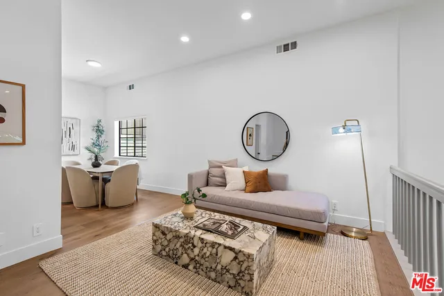 a living room with furniture a rug and a window