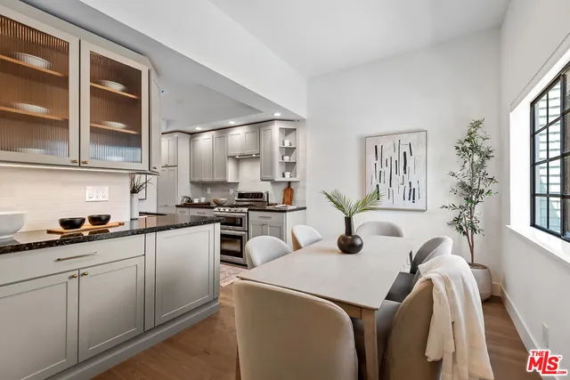 a kitchen with stainless steel appliances granite countertop a sink a stove and cabinets