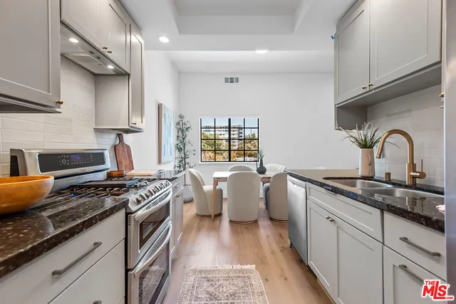 a kitchen with a sink stove and cabinets