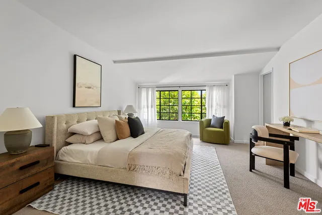 a bedroom with a bed and a couch