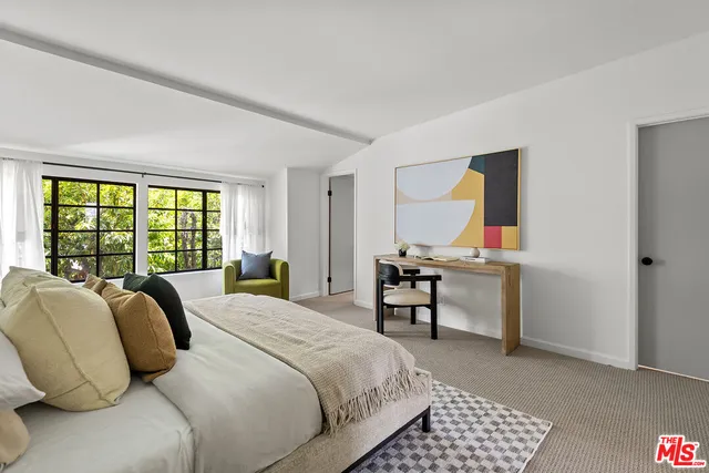 a bedroom with a bed and a table