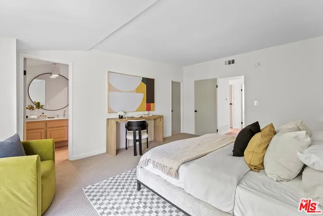 a bedroom with a bed and a couch