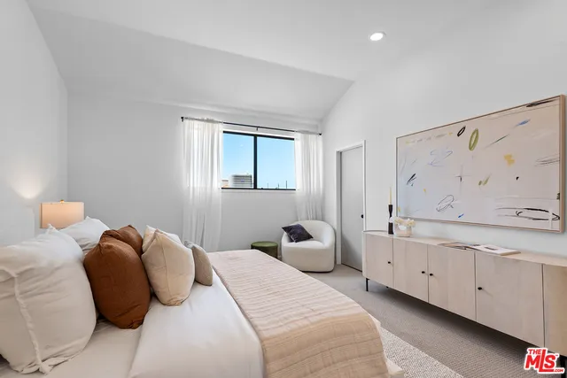 a bedroom with two beds and a chandelier