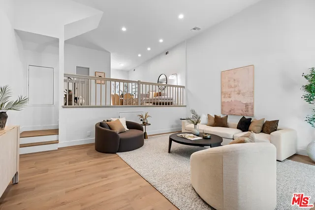 a living room with furniture and a ceiling fan