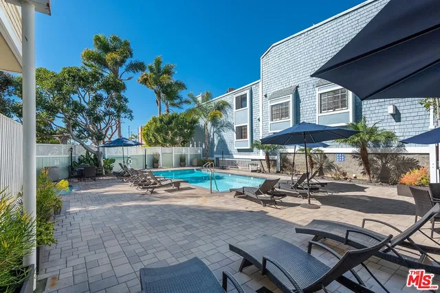 a view of a patio with table and chairs and potted plants