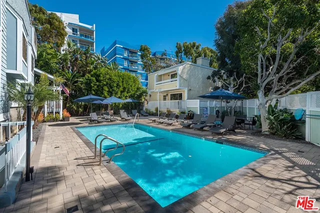 a view of a patio with swimming pool table and chairs