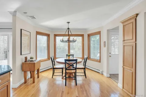 a dining room with furniture window wooden floor