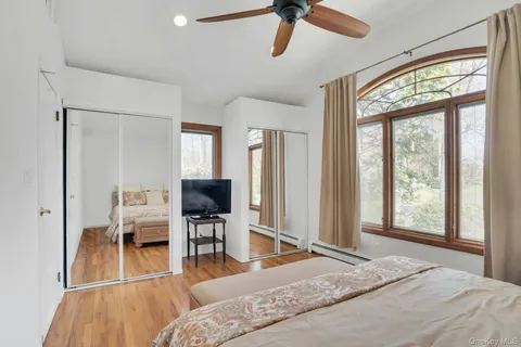 a bedroom with a large bed and a lamp