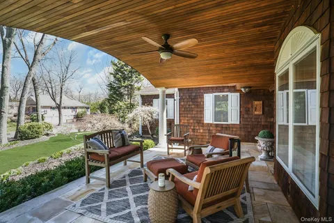 a living room with patio furniture and garden