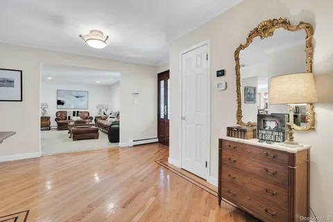a bedroom with furniture and a wooden floor