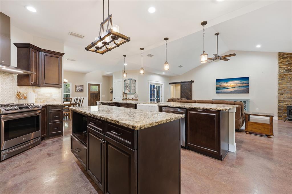 357 Southwest Conestoga Way Fort White, FL 32038 - Photo 11 of 44 a kitchen with stainless steel appliances granite countertop a stove a sink and a refrigerator