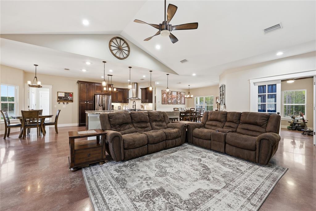 357 Southwest Conestoga Way Fort White, FL 32038 - Photo 21 of 44 a living room with furniture a large window and a chandelier