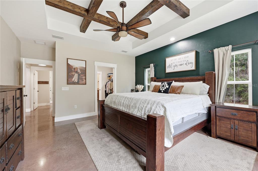 357 Southwest Conestoga Way Fort White, FL 32038 - Photo 24 of 44 a bedroom with a large bed chandelier and a window