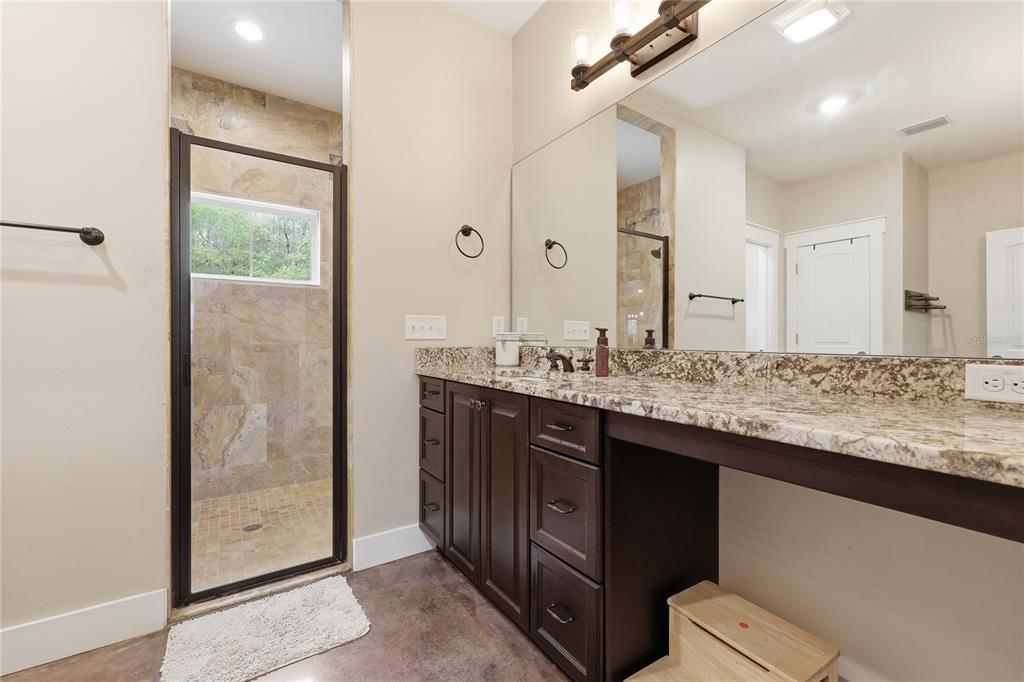 357 Southwest Conestoga Way Fort White, FL 32038 - Photo 26 of 44 a bathroom with a granite countertop sink and a mirror