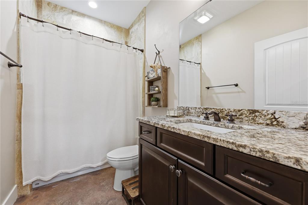 357 Southwest Conestoga Way Fort White, FL 32038 - Photo 30 of 44 a bathroom with a granite countertop sink toilet and shower