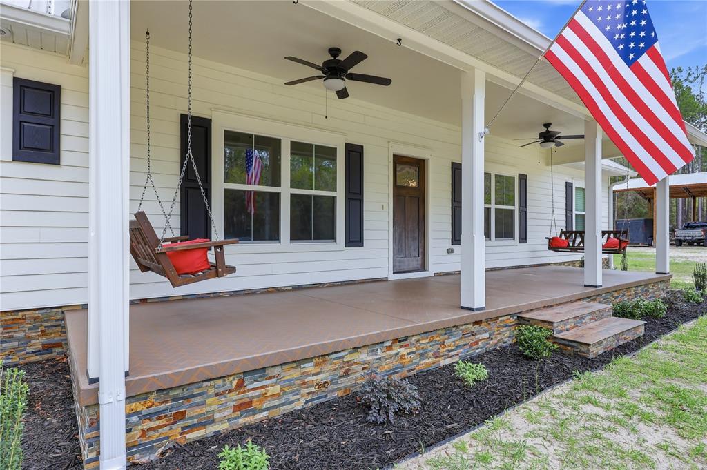 357 Southwest Conestoga Way Fort White, FL 32038 - Photo 4 of 44 a front view of a house with a yard