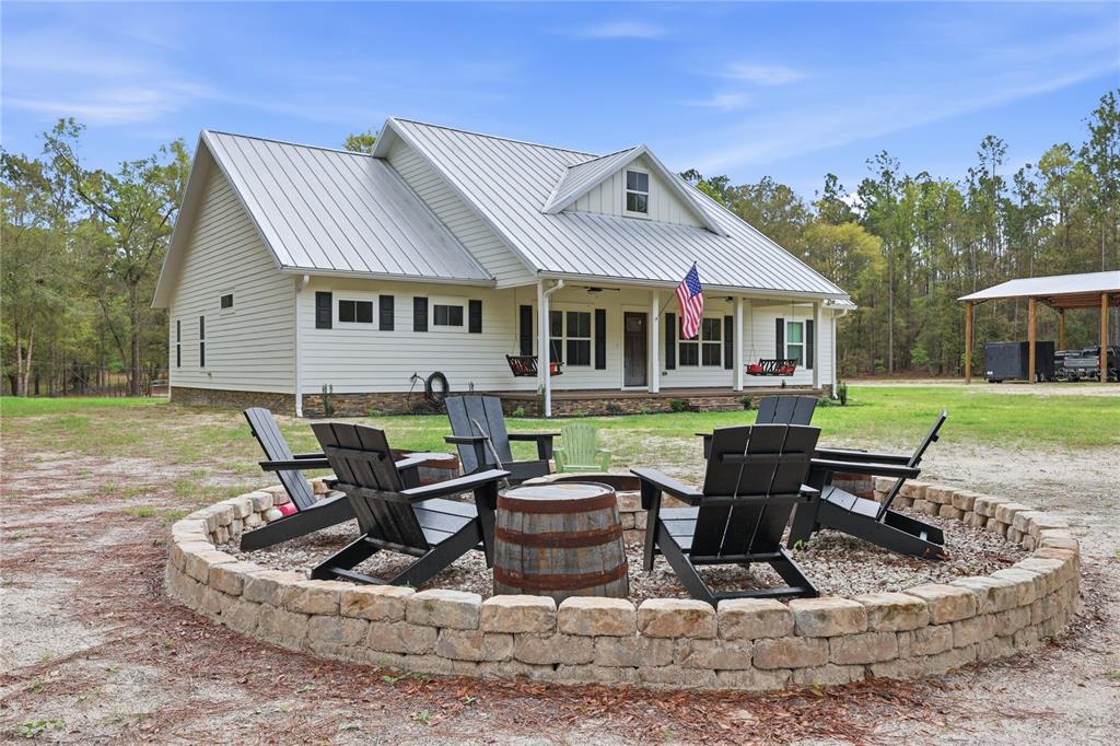 357 Southwest Conestoga Way Fort White, FL 32038 - Photo 5 of 44 a view of a house with backyard sitting area and furniture