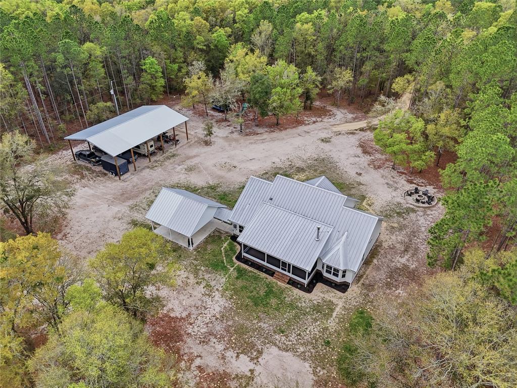 357 Southwest Conestoga Way Fort White, FL 32038 - Photo 8 of 44 an aerial view of a backyard with a barn