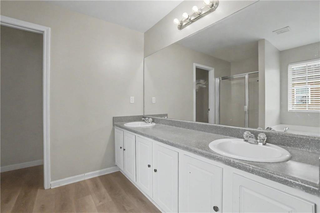 375 Walton View Fairburn, GA 30213 - Photo 26 of 38 a bathroom with a granite countertop sink and a mirror
