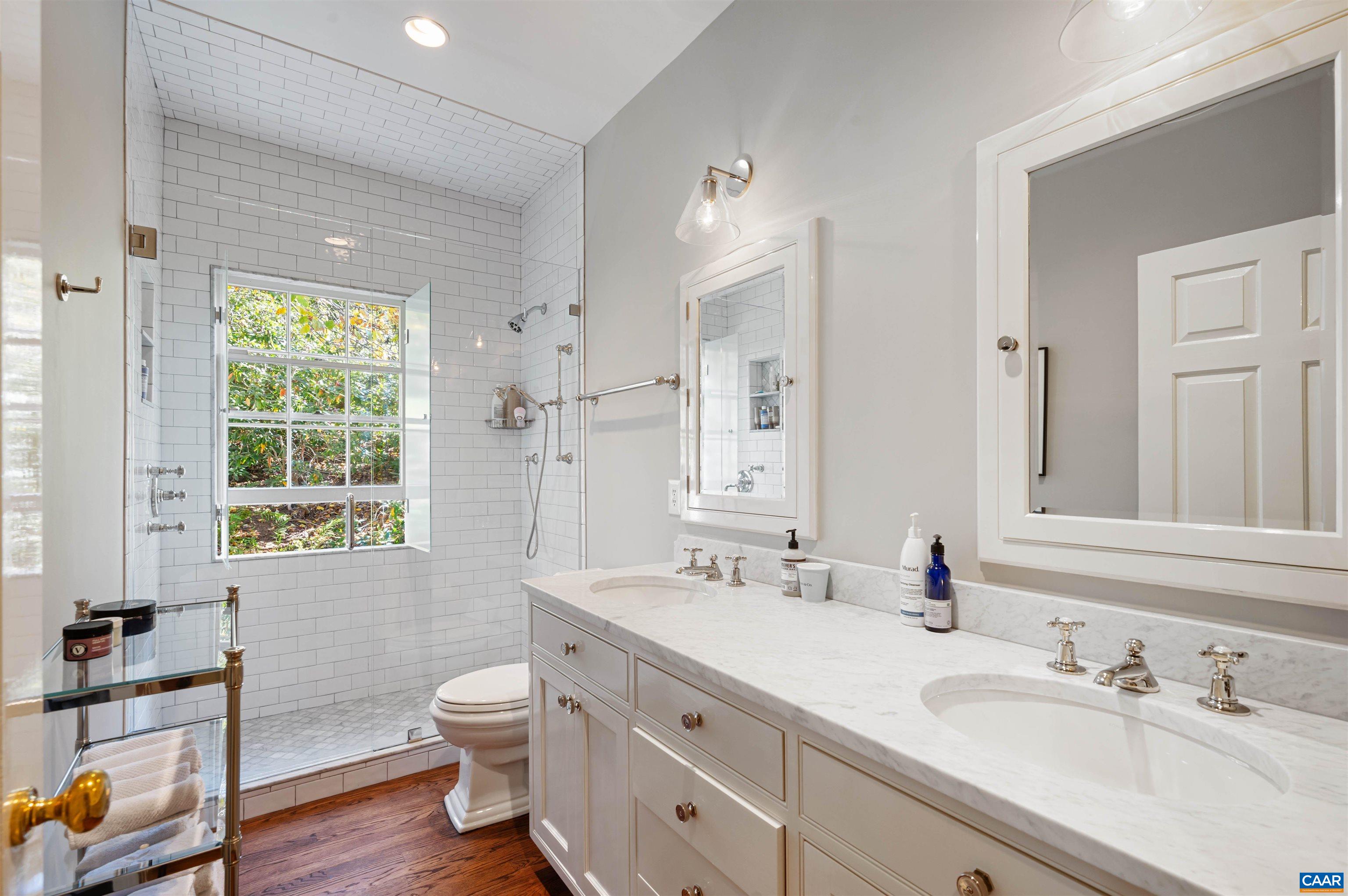 31 Old Farm Road Charlottesville, VA 22903 - Photo 39 of 62 a bathroom with a granite countertop toilet a sink a mirror and a window