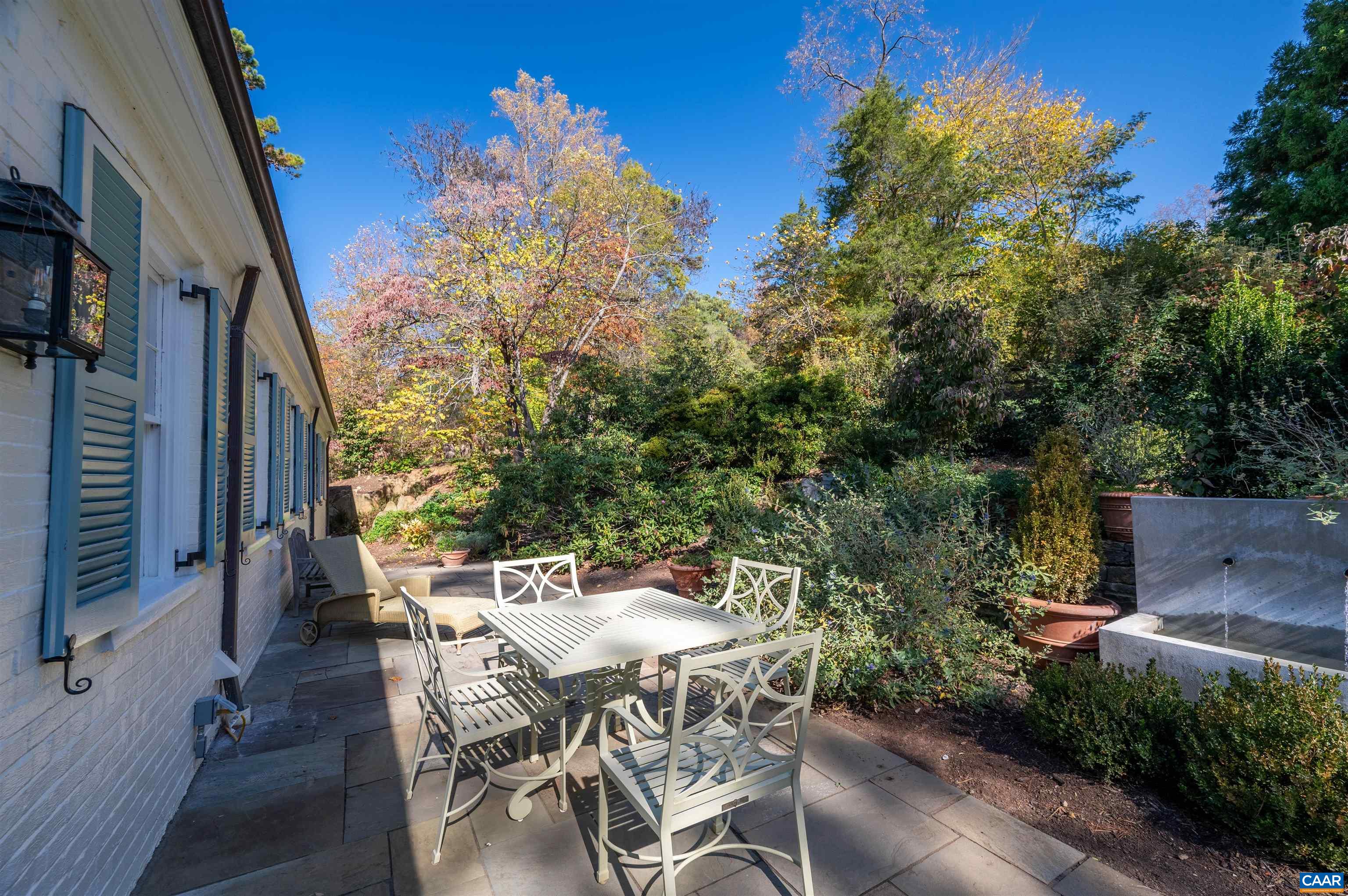31 Old Farm Road Charlottesville, VA 22903 - Photo 53 of 62 a view of a patio with table and chairs and potted plants with wooden floor