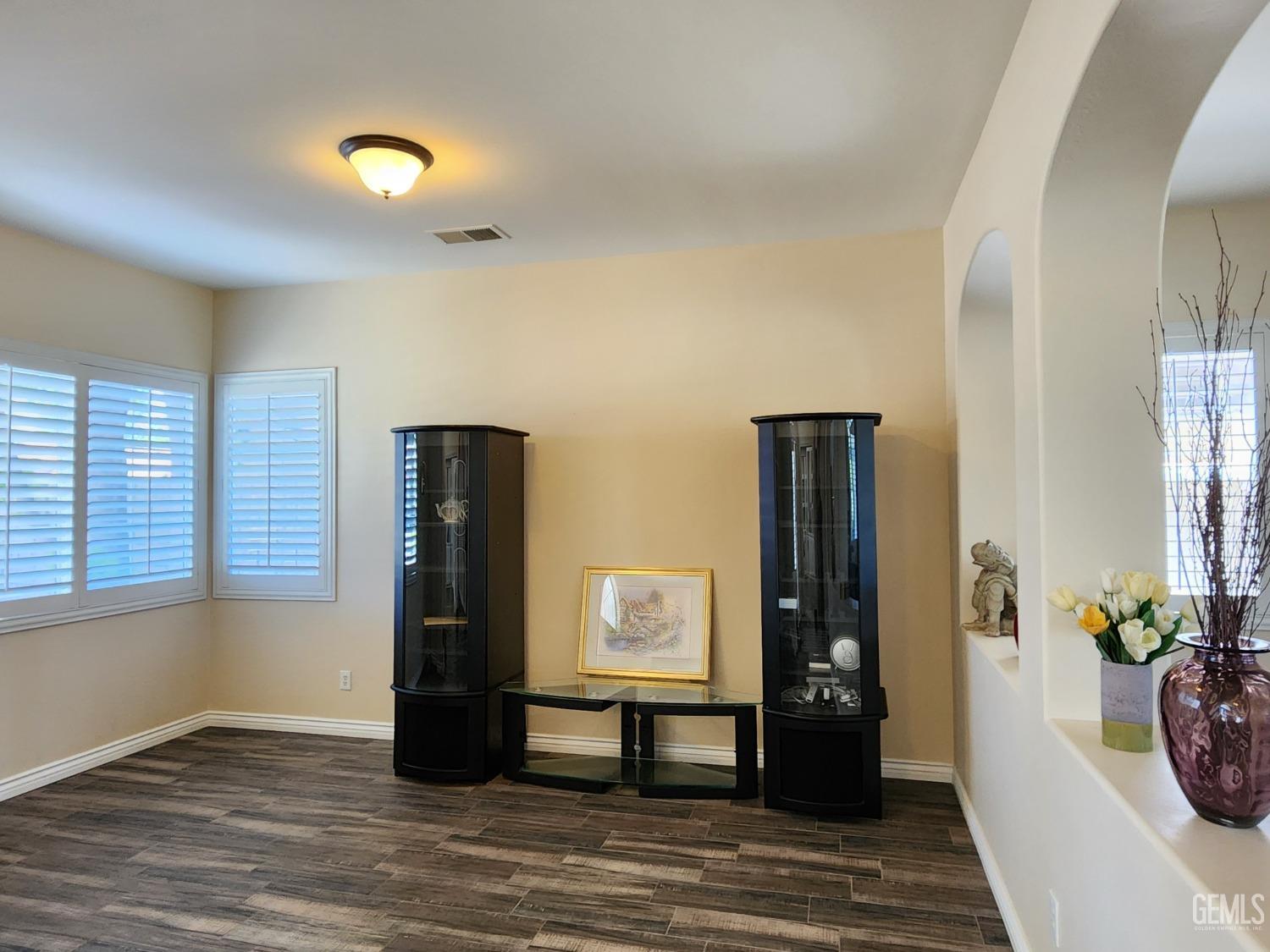 Undisclosed Address Bakersfield, CA 93312 - Photo 13 of 44 a view of a hallway with wooden floor and windows