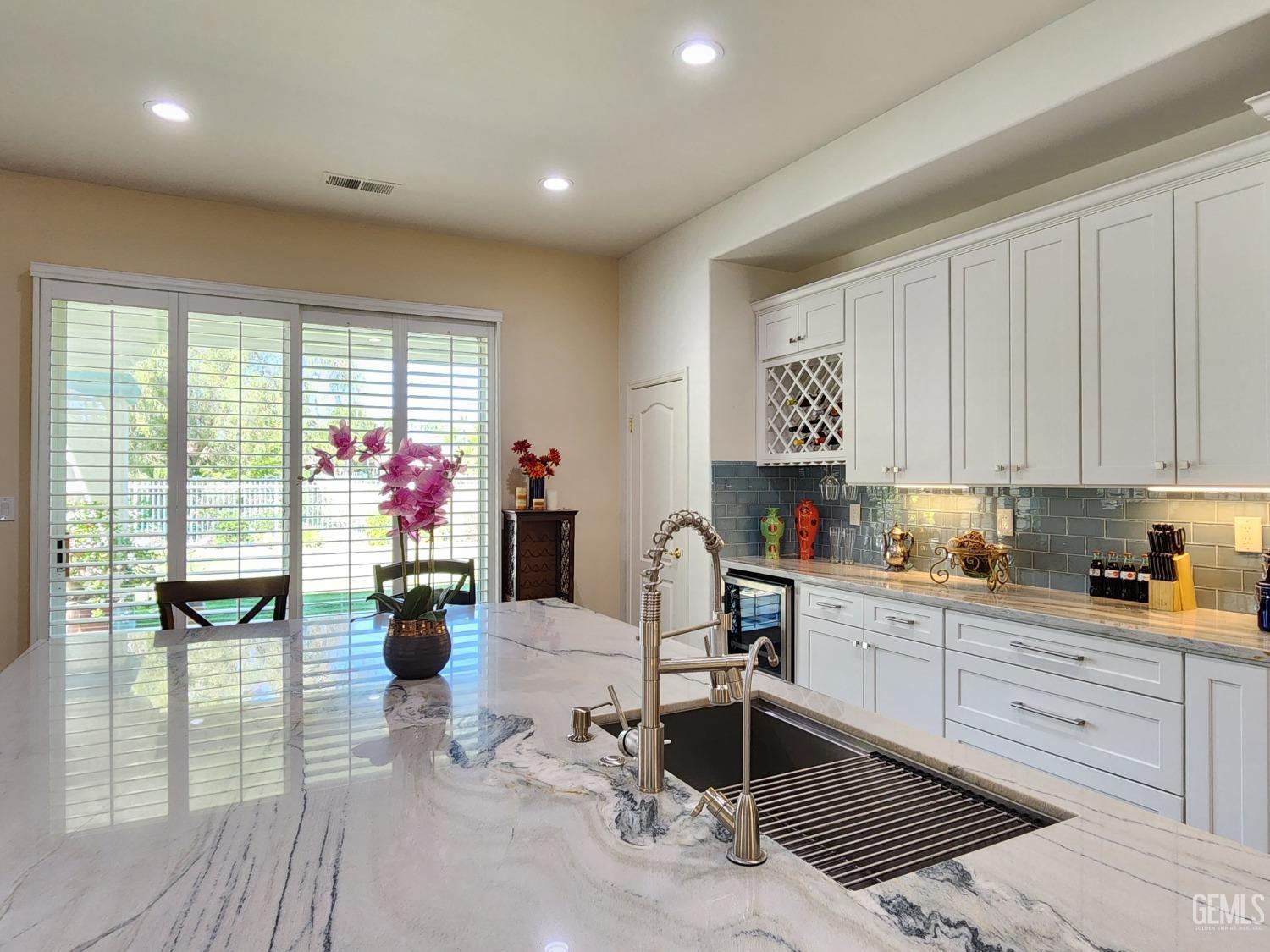 Undisclosed Address Bakersfield, CA 93312 - Photo 14 of 44 a kitchen filled with a potted plant on the kitchen table and chairs