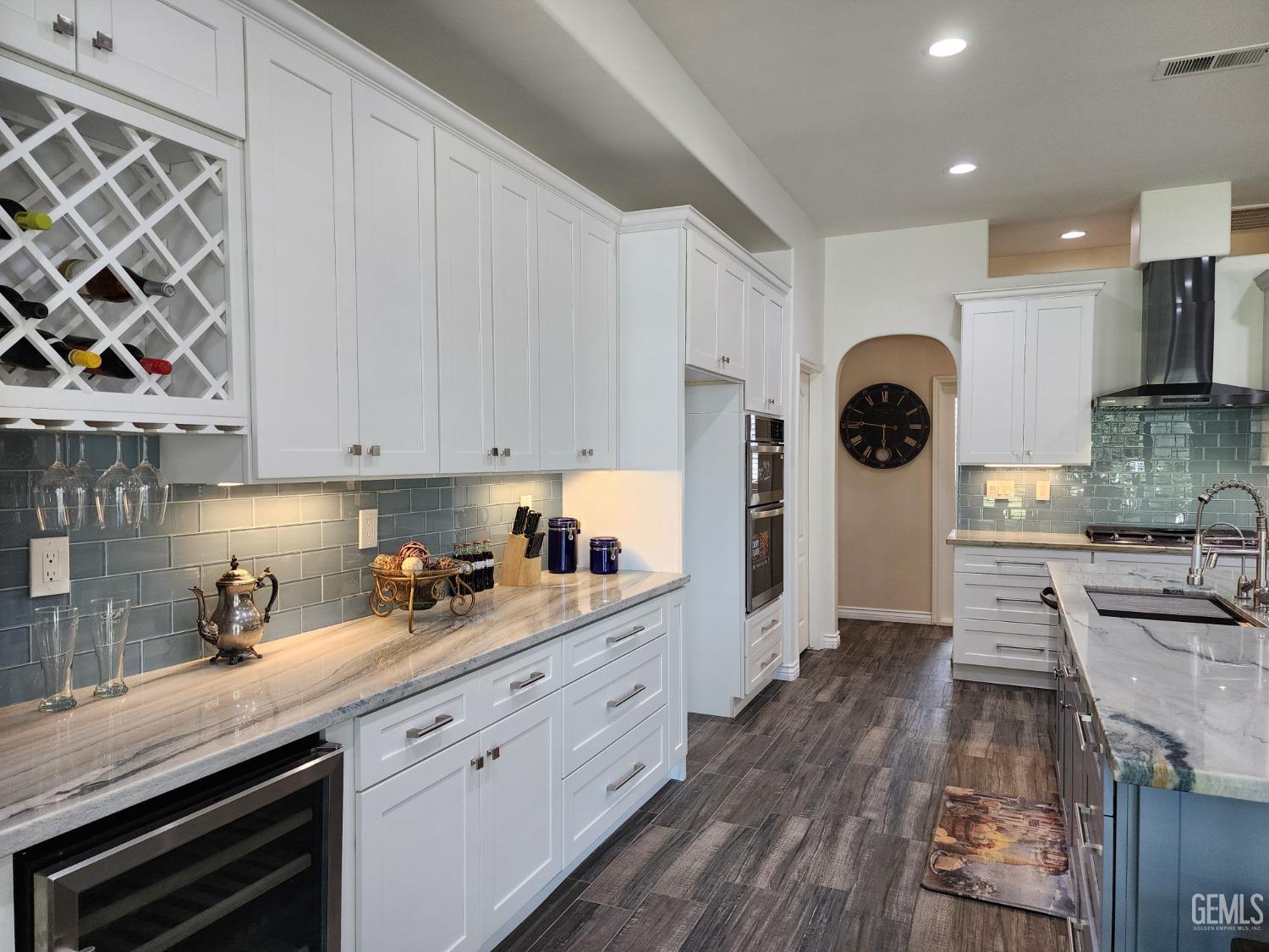 Undisclosed Address Bakersfield, CA 93312 - Photo 15 of 44 a kitchen with stainless steel appliances granite countertop a sink a stove and cabinets