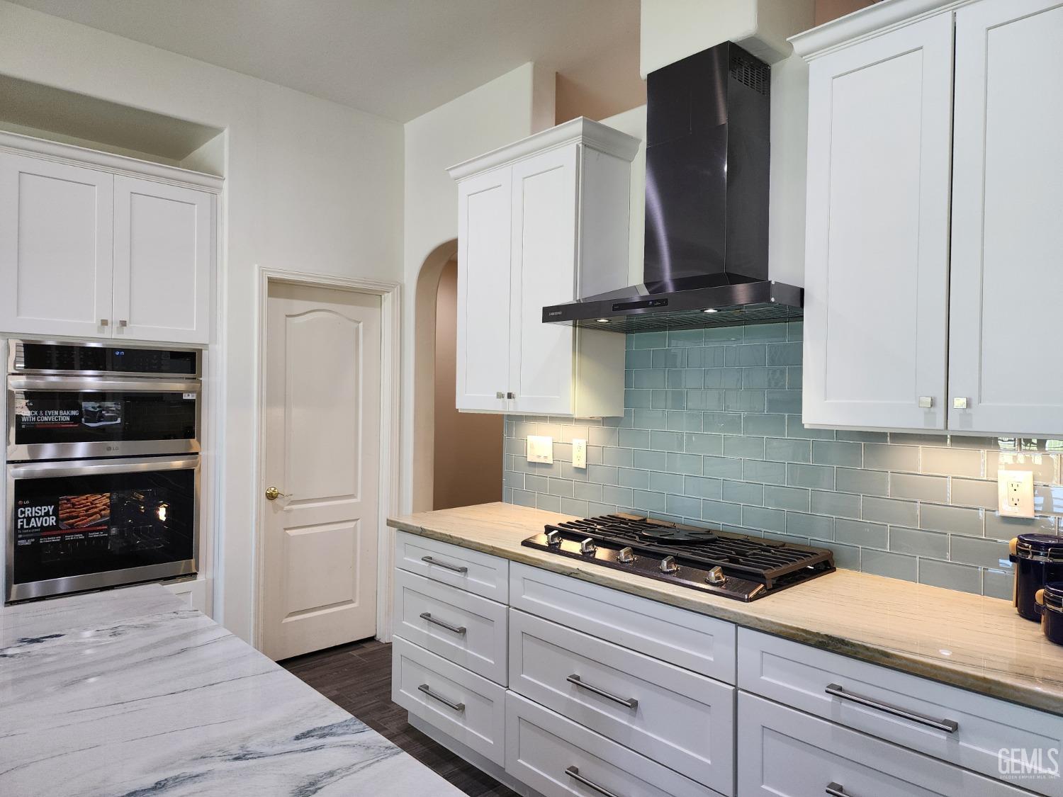 Undisclosed Address Bakersfield, CA 93312 - Photo 16 of 44 a kitchen with granite countertop a stove and a refrigerator