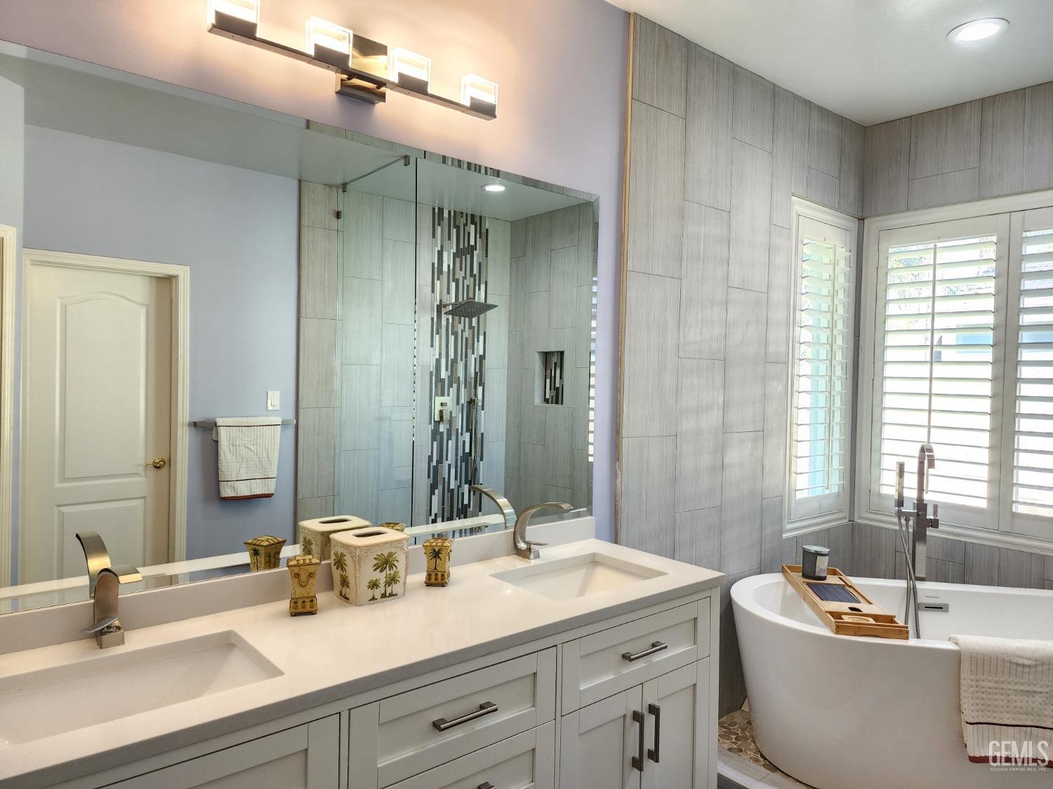 Undisclosed Address Bakersfield, CA 93312 - Photo 25 of 44 a bathroom with a double vanity sink and a bathtub