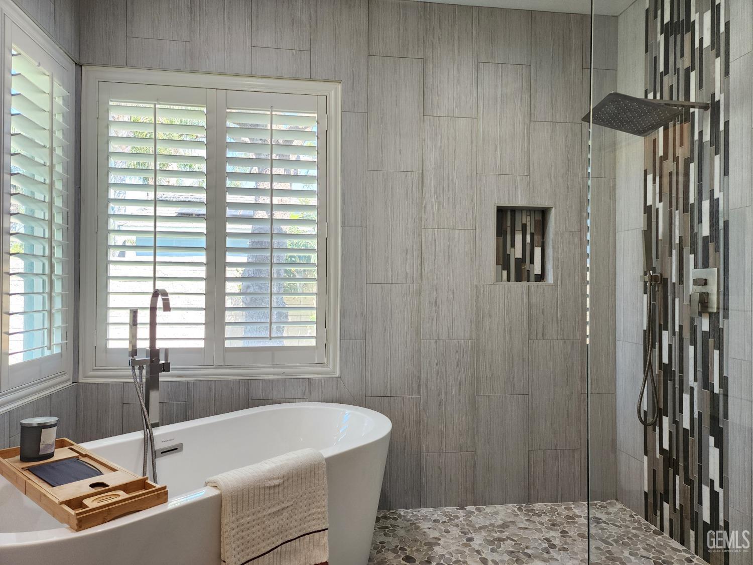 Undisclosed Address Bakersfield, CA 93312 - Photo 26 of 44 a bathroom with a tub a sink and a window