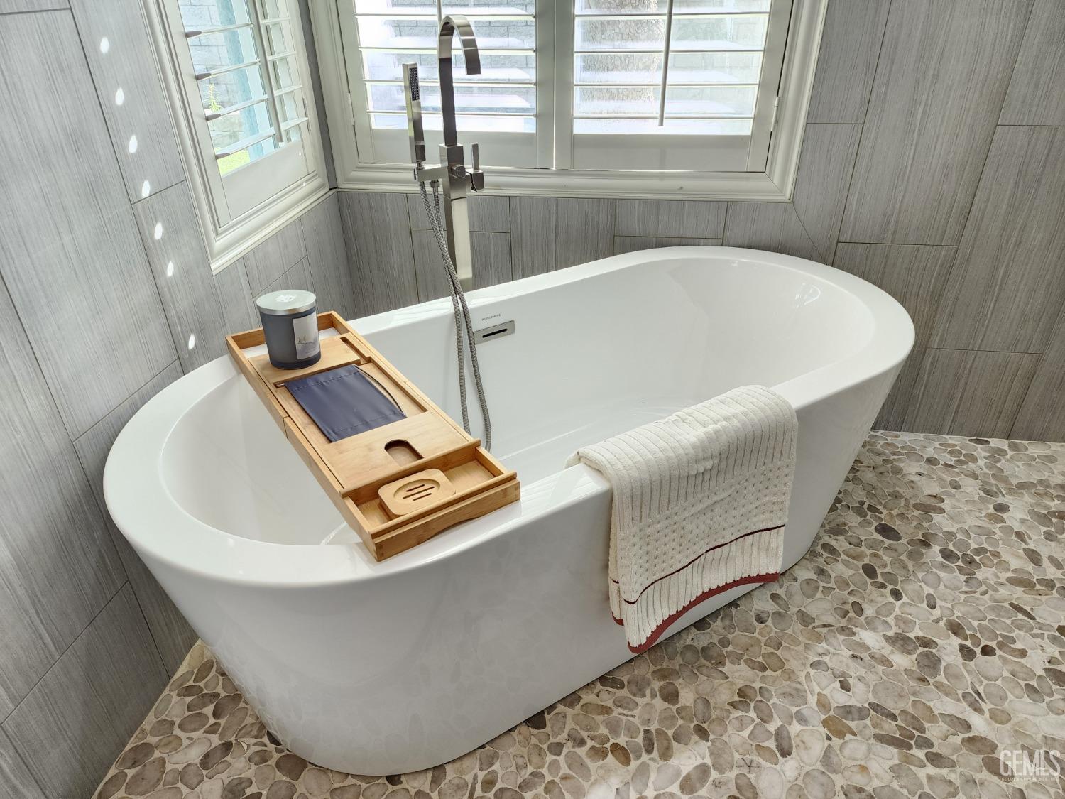 Undisclosed Address Bakersfield, CA 93312 - Photo 27 of 44 a white bath tub sitting in a bathroom