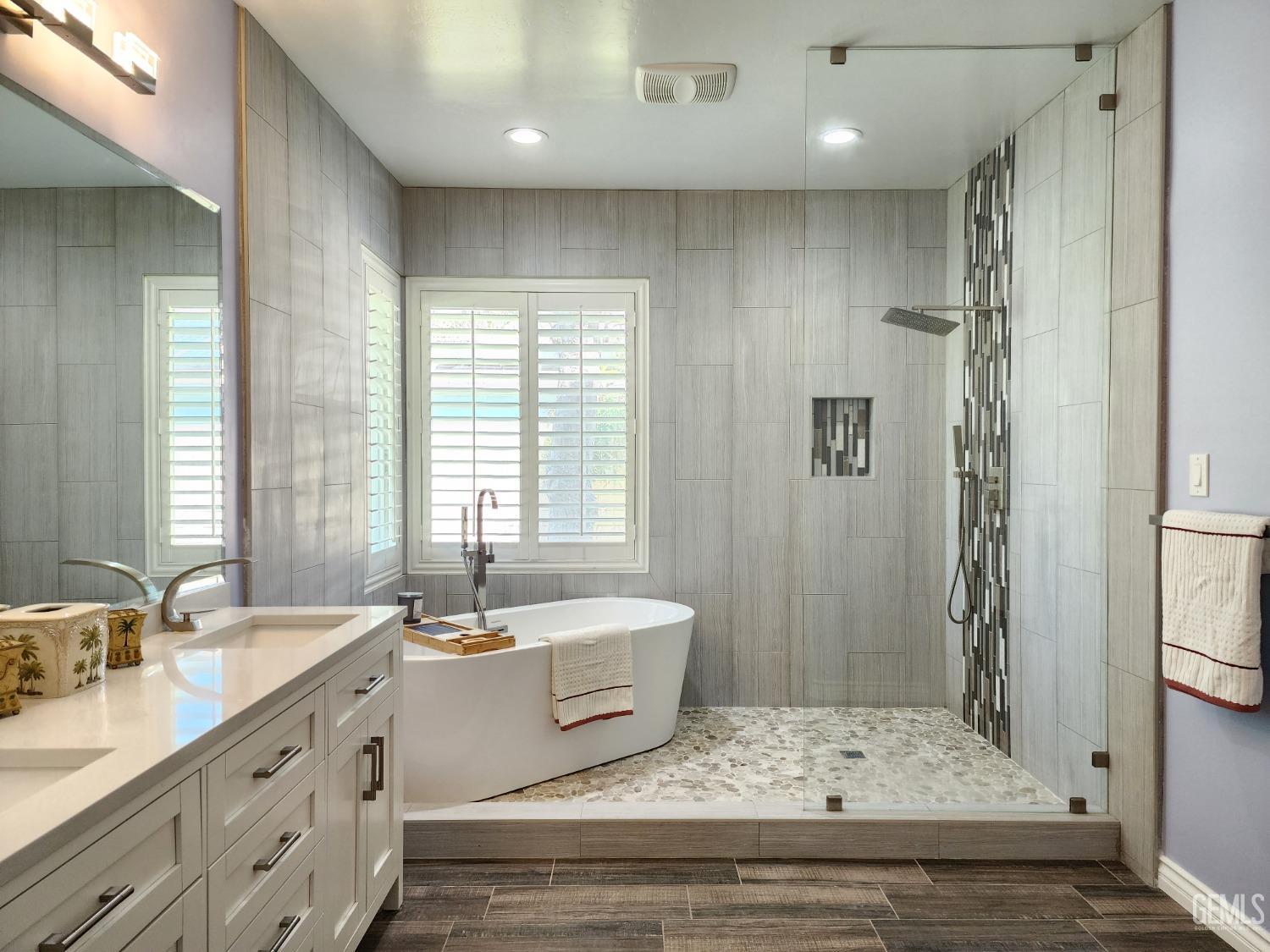 Undisclosed Address Bakersfield, CA 93312 - Photo 3 of 44 a bathroom with a double vanity sink a mirror and a shower