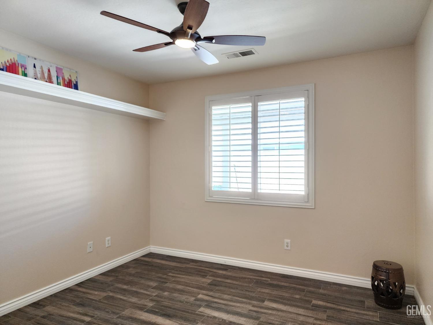 Undisclosed Address Bakersfield, CA 93312 - Photo 33 of 44 a view of an empty room with wooden floor and a window