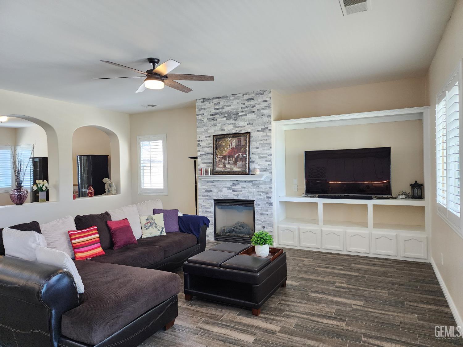 Undisclosed Address Bakersfield, CA 93312 - Photo 4 of 44 a living room with furniture a flat screen tv and a fireplace