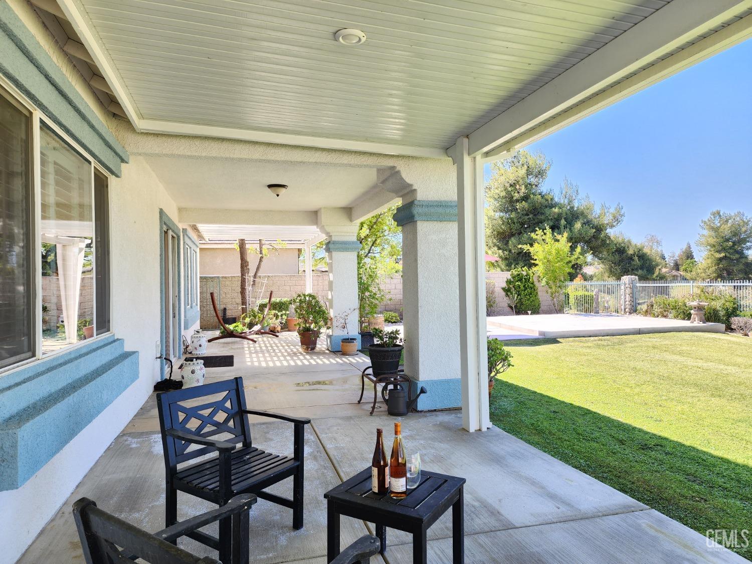 Undisclosed Address Bakersfield, CA 93312 - Photo 43 of 44 a view of a patio with table and chairs and potted plants