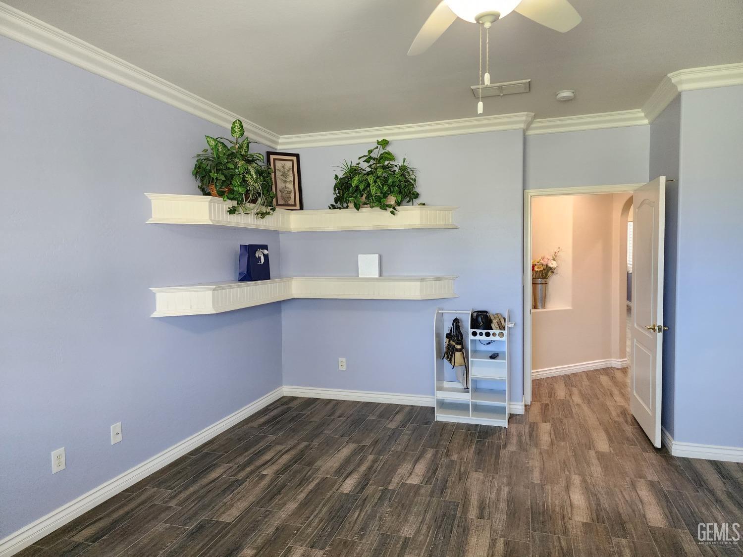 Undisclosed Address Bakersfield, CA 93312 - Photo 7 of 44 a view of a room with wooden floor and cabinet