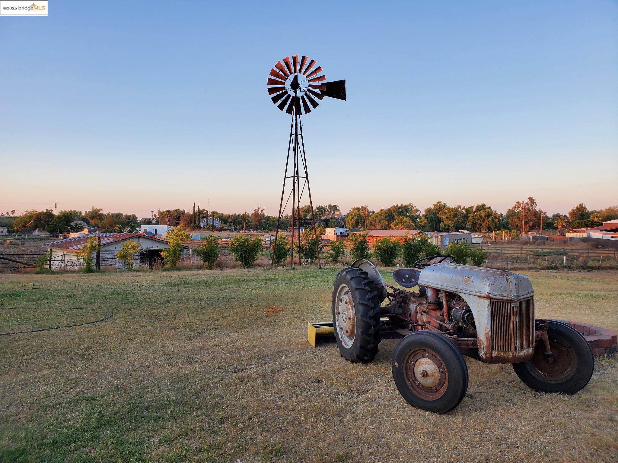 Yard at dusk featuring a lawn