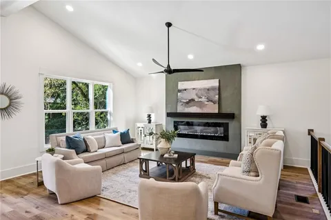 a living room with furniture and kitchen view