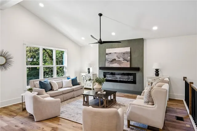 a living room with furniture and kitchen view