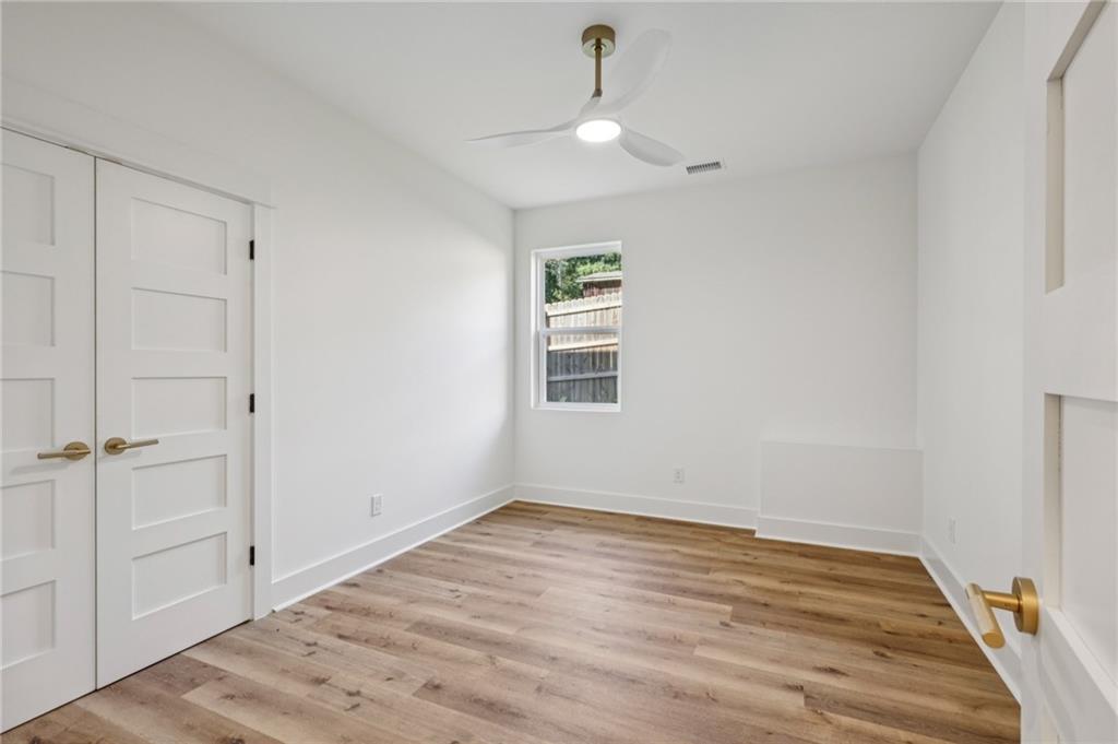 2387 Cranbrooke Drive Decatur, GA 30032 - Photo 26 of 44 wooden floor in an empty room with a window