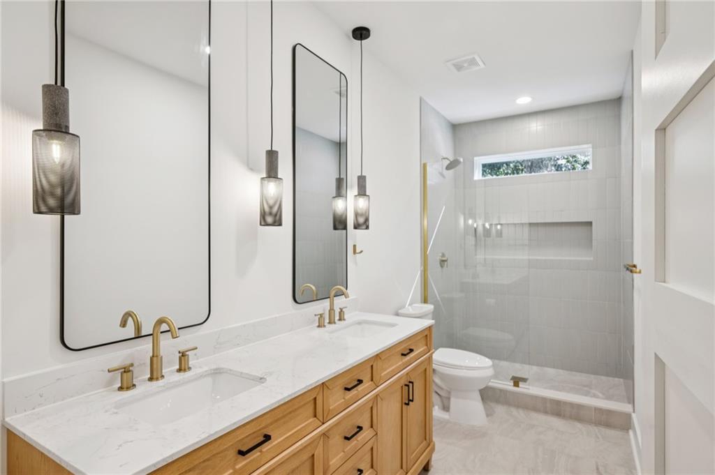 2387 Cranbrooke Drive Decatur, GA 30032 - Photo 27 of 44 a bathroom with a double vanity sink toilet and shower